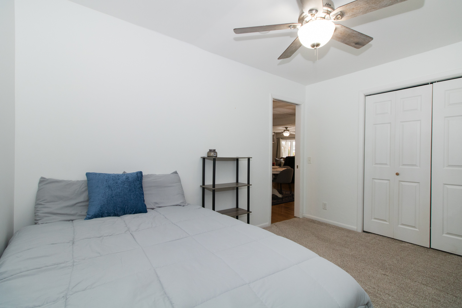 1501 Searle Drive Normal, IL 61761 - Photo 17 of 31 a bedroom with a large bed and a chandelier