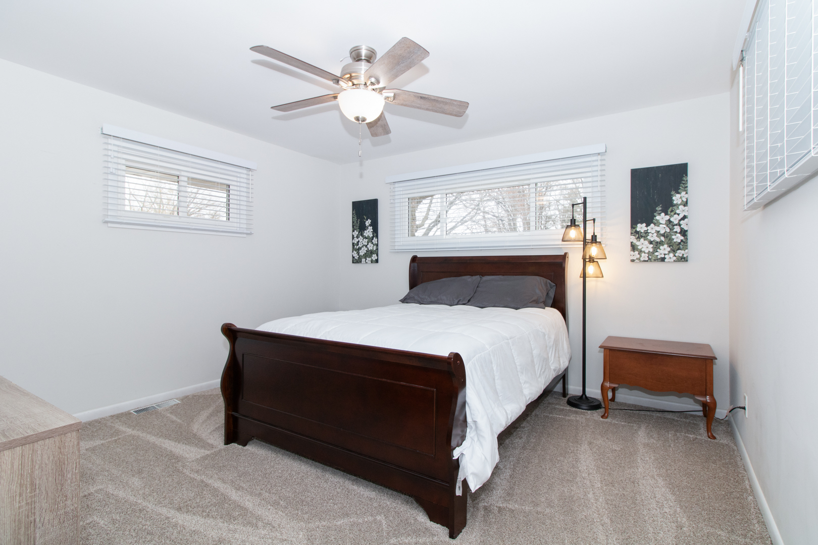 1501 Searle Drive Normal, IL 61761 - Photo 18 of 31 a bedroom with a bed lamp and a chandelier