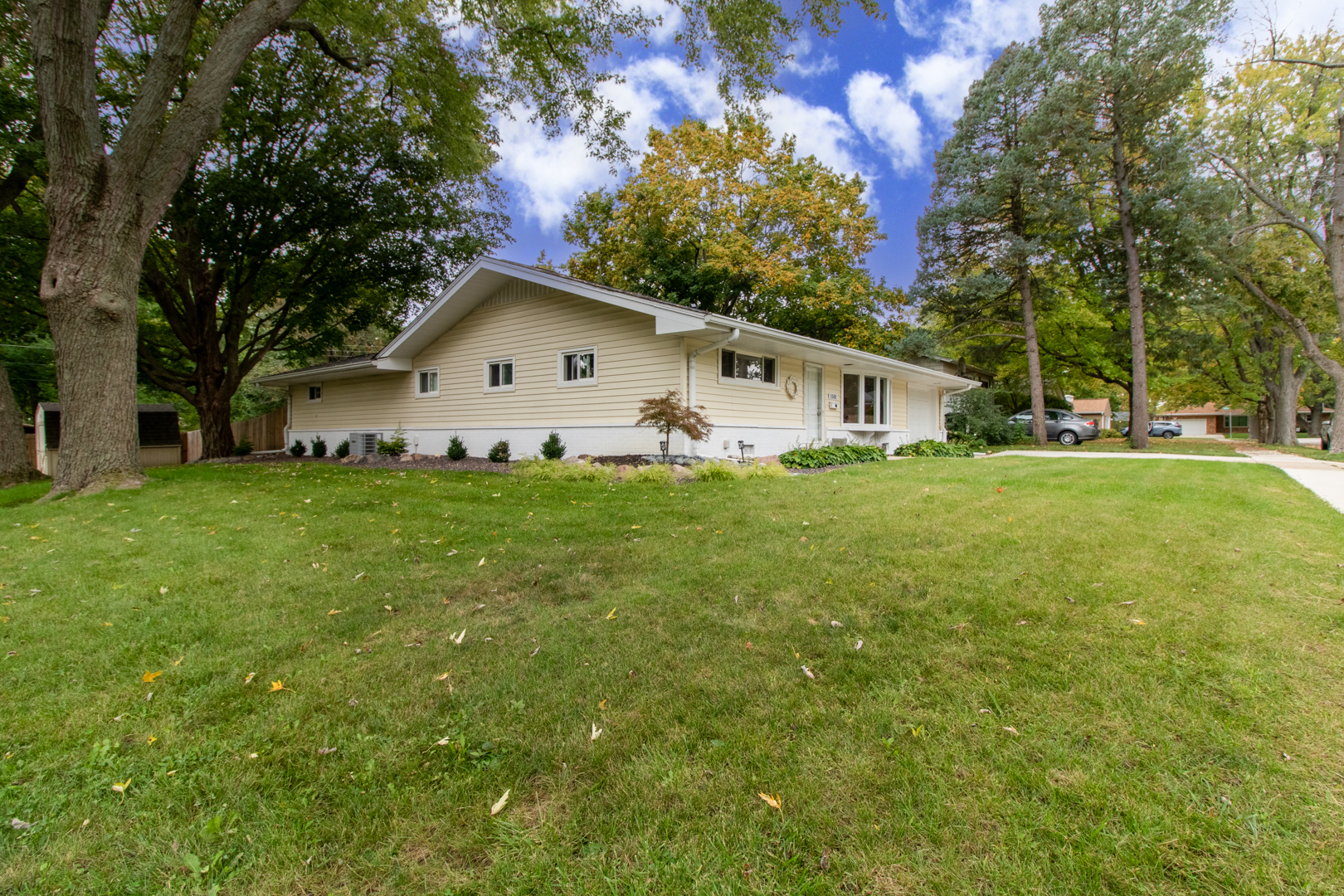 1501 Searle Drive Normal, IL 61761 - Photo 28 of 31 a house that is sitting in the grass with large trees and plants