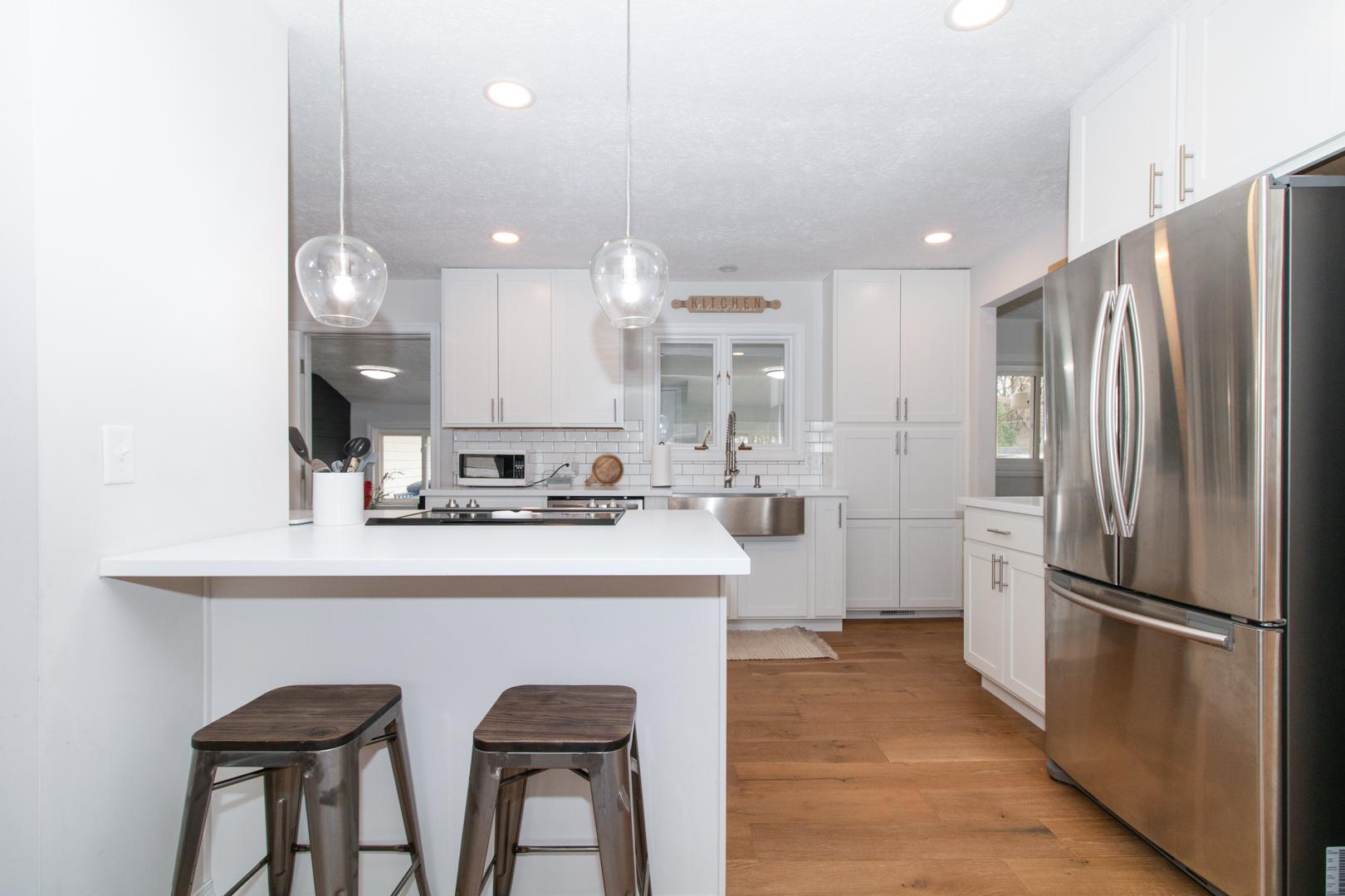 1501 Searle Drive Normal, IL 61761 - Photo 5 of 31 a kitchen with kitchen island white cabinets and stainless steel appliances
