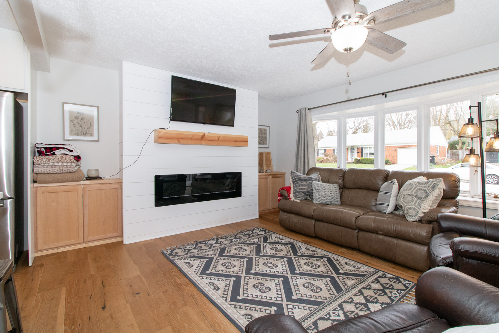 1501 Searle Drive Normal, IL 61761 - Photo 6 of 31 a living room with furniture a flat screen tv and a fireplace