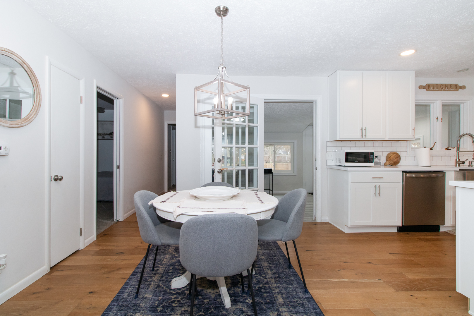 1501 Searle Drive Normal, IL 61761 - Photo 9 of 31 a dining room with wooden floor a chandelier a wooden table and chairs