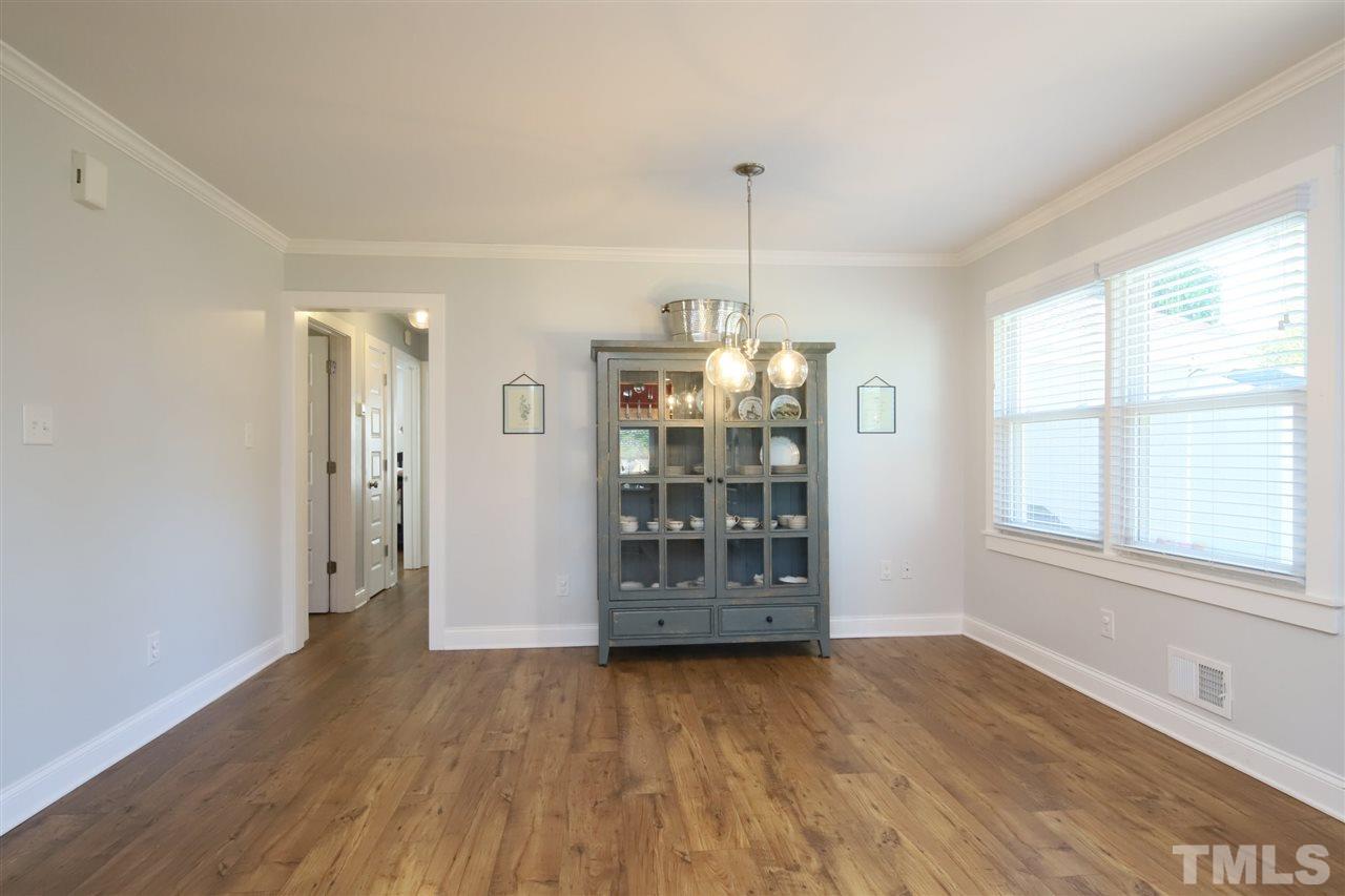 1308 East Lane Street Raleigh, NC 27610 - Photo 12 of 21 an empty room with wooden floor and windows