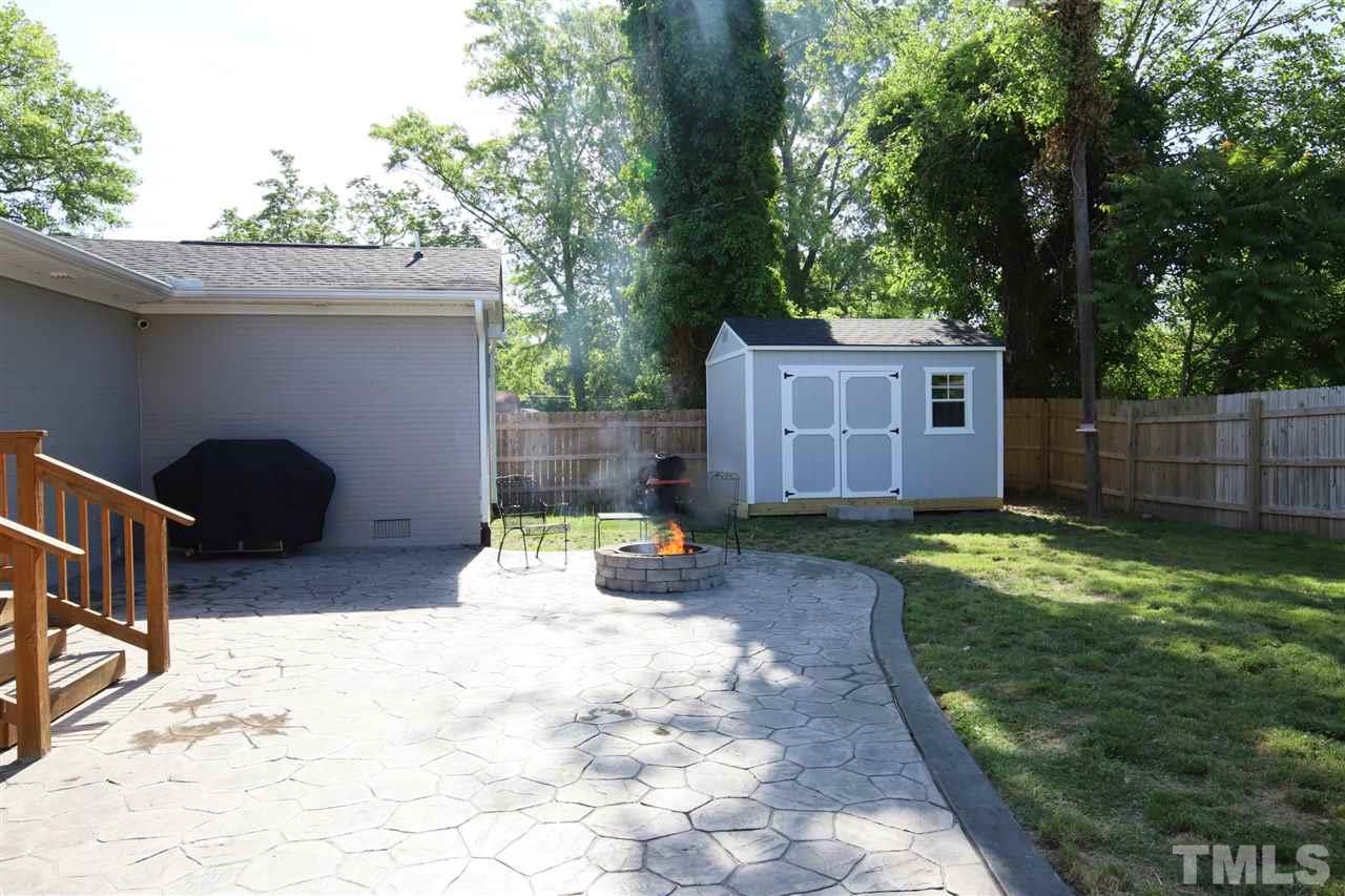 1308 East Lane Street Raleigh, NC 27610 - Photo 4 of 21 a backyard of a house with yard and outdoor seating