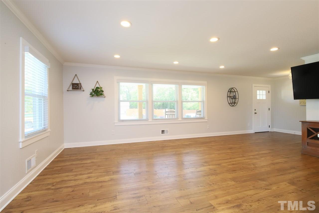 1308 East Lane Street Raleigh, NC 27610 - Photo 9 of 21 wooden floor in an empty room with a window