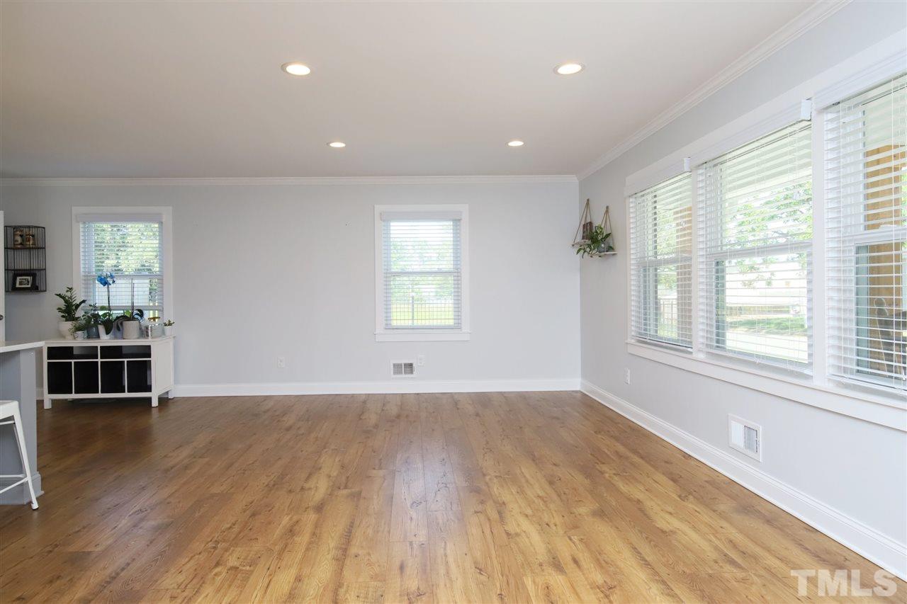 1308 East Lane Street Raleigh, NC 27610 - Photo 10 of 21 an empty room with wooden floor and windows