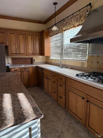 a view of a kitchen with stainless steel appliances granite countertop a sink and a counter