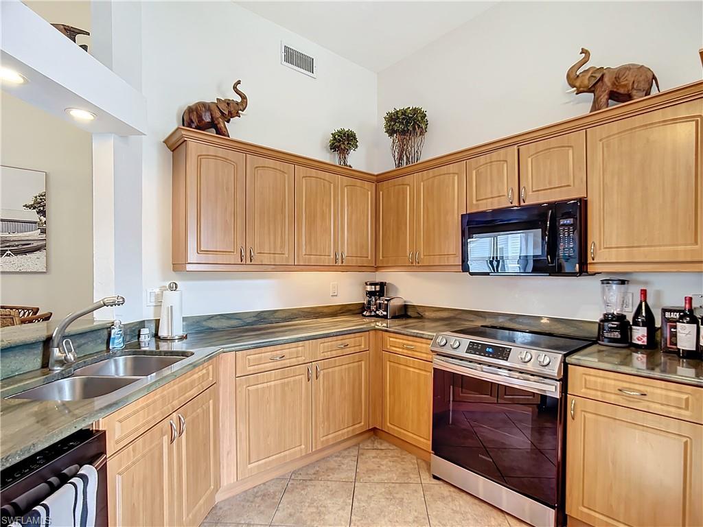 2860 Citrus Lake Drive, Unit R202 Naples, FL 34109 - Photo 10 of 50 a kitchen with stainless steel appliances granite countertop a sink stove and cabinets
