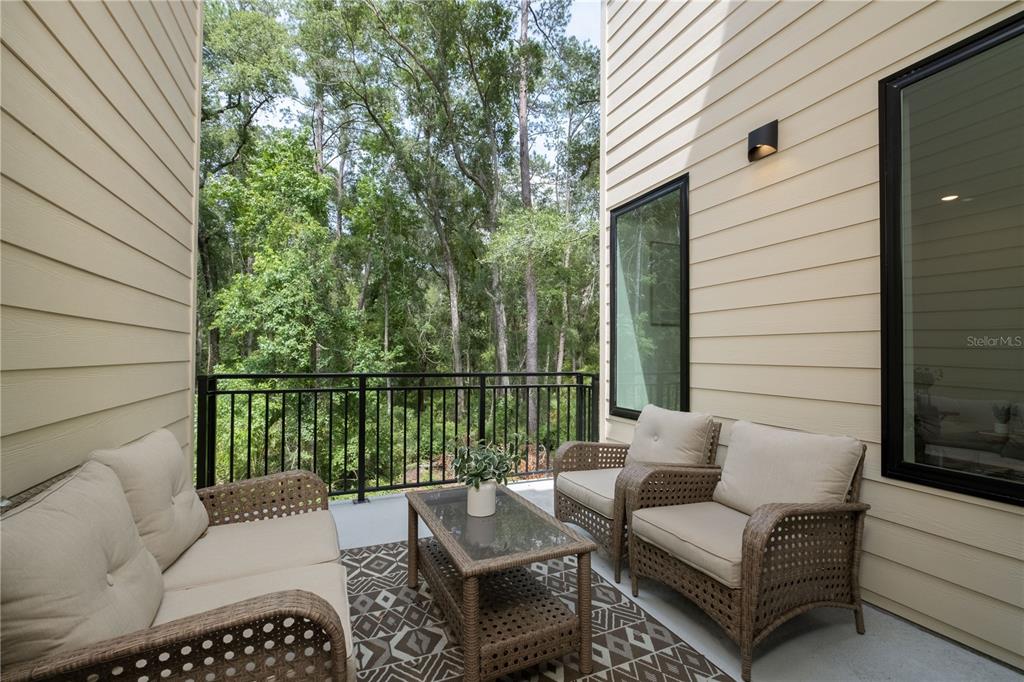 2601 Southwest Williston Road, Unit 2 Gainesville, FL 32608 - Photo 28 of 39 a balcony with furniture and a potted plant