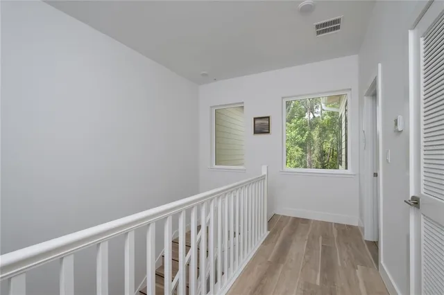 a view of a small space with wooden floor and a window