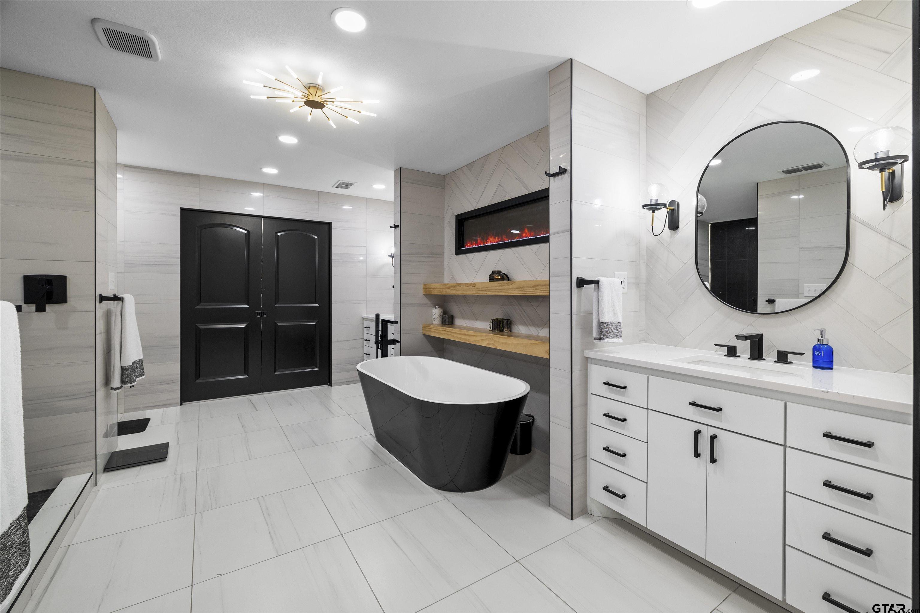 1300 Montclair Street Longview, TX 75601 - Photo 16 of 40 a spacious bathroom with a sink a toilet and a mirror
