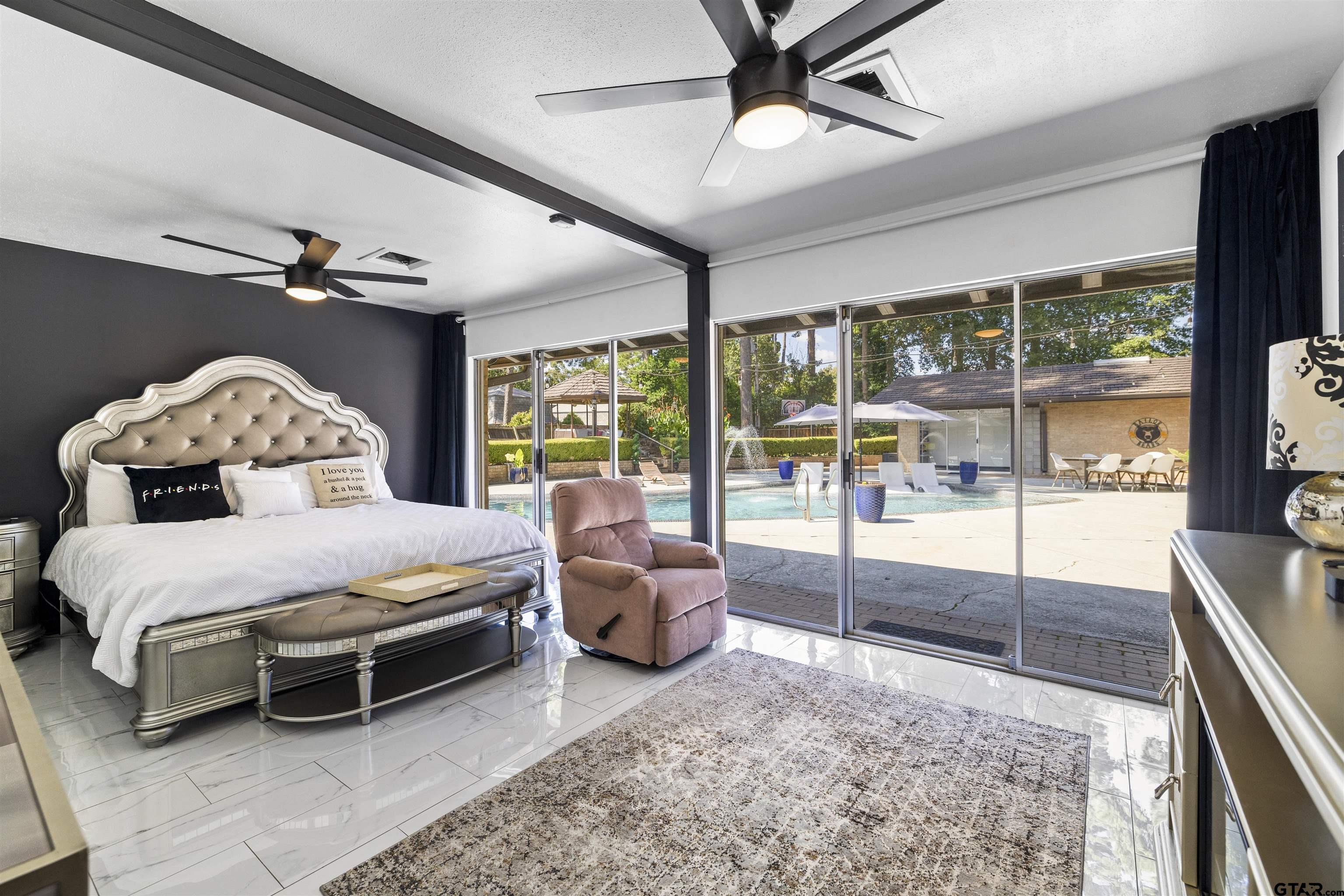 1300 Montclair Street Longview, TX 75601 - Photo 20 of 40 a spacious bedroom with a bed and large window