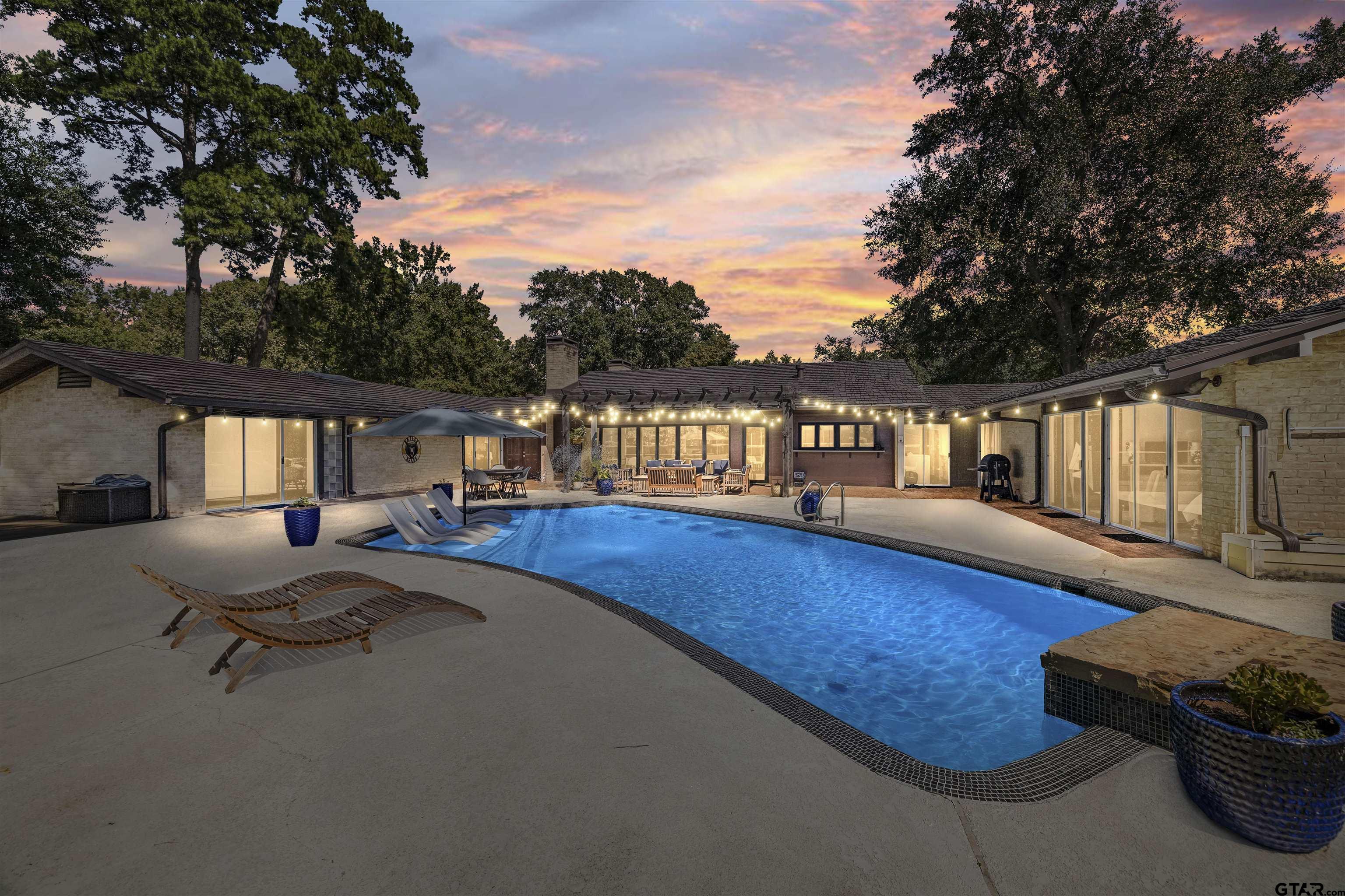 1300 Montclair Street Longview, TX 75601 - Photo 2 of 40 a view of a swimming pool with lounge chair