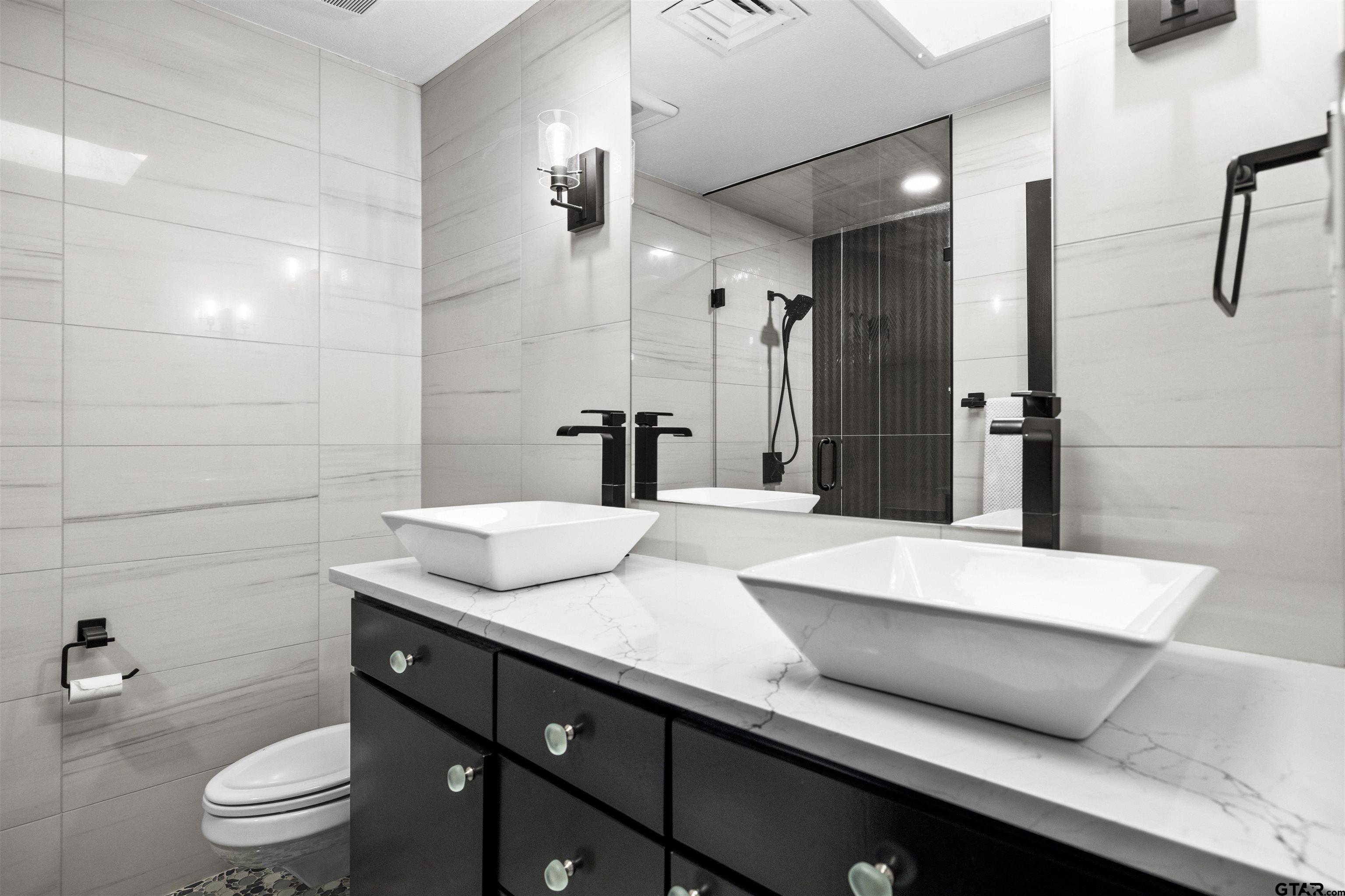 1300 Montclair Street Longview, TX 75601 - Photo 22 of 40 a bathroom with a sink a toilet and shower