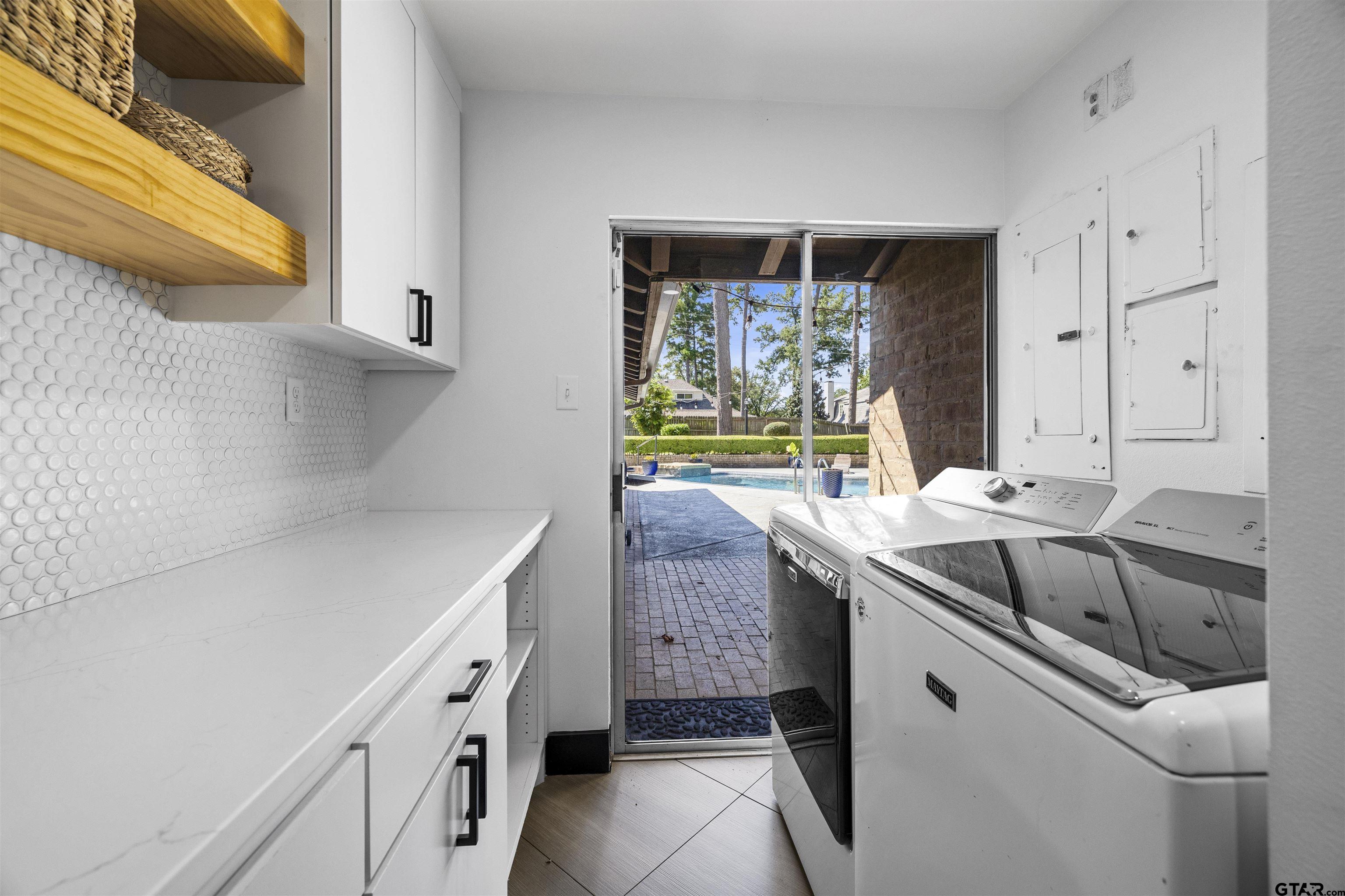 1300 Montclair Street Longview, TX 75601 - Photo 25 of 40 a kitchen with a sink stove and cabinets