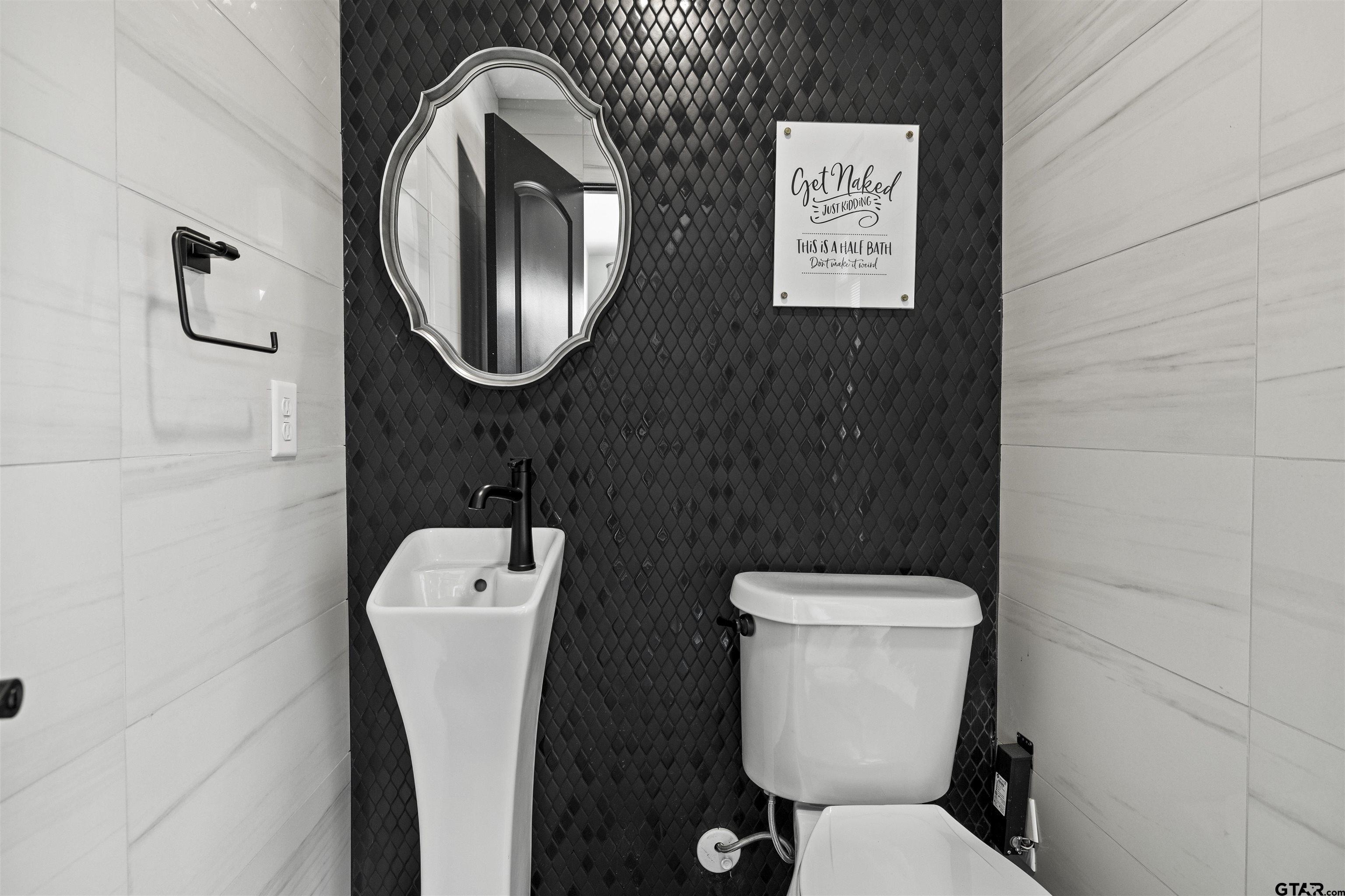 1300 Montclair Street Longview, TX 75601 - Photo 27 of 40 a bathroom with a toilet and a sink