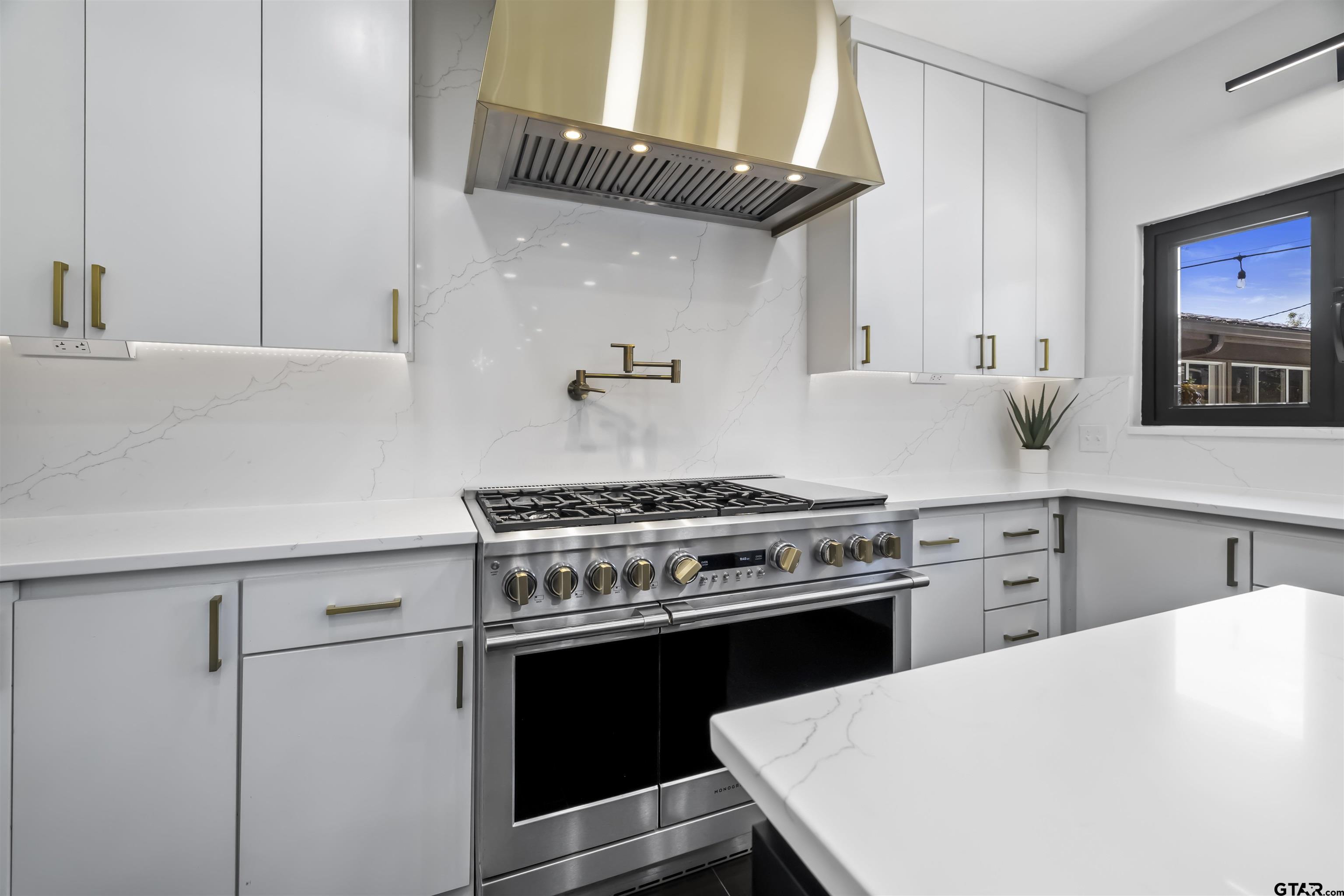 1300 Montclair Street Longview, TX 75601 - Photo 9 of 40 a kitchen with a stove a sink and a refrigerator