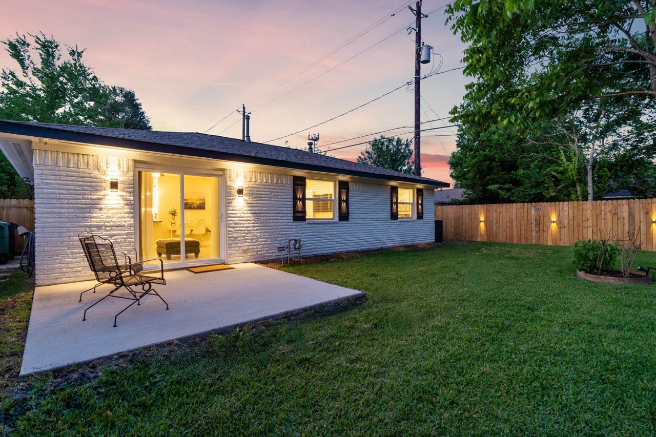 3138 Sunbeam Street Houston, TX 77051 - Photo 45 of 50 Twilight views elevate this backyard escape with warm ambient lighting and the perfect patio for evening relaxation.