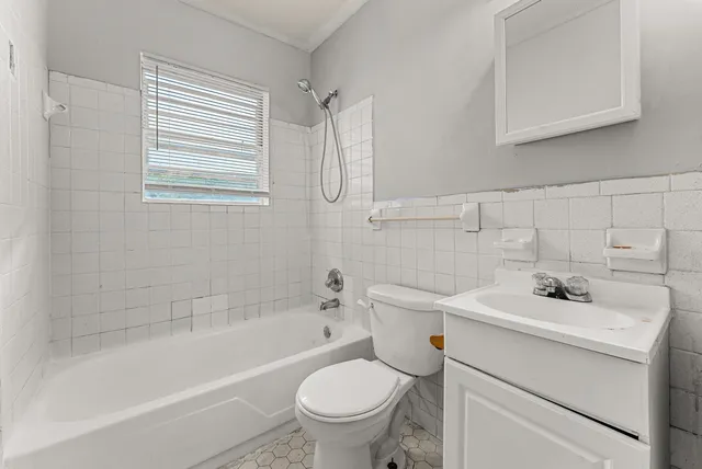 a bathroom with a sink toilet vanity and bathtub