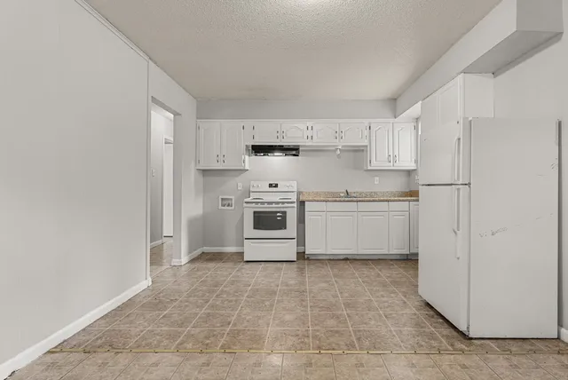 a kitchen with stainless steel appliances a sink and a refrigerator