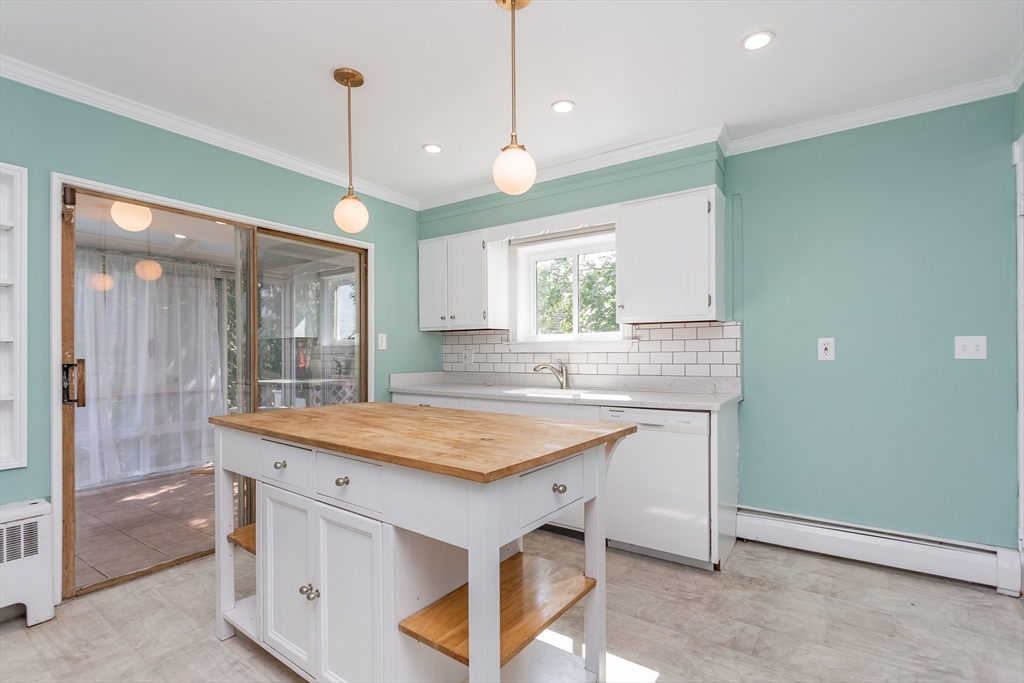 724 High Street Fall River, MA 02720 - Photo 9 of 39 a kitchen with a stove a sink and a wooden floor