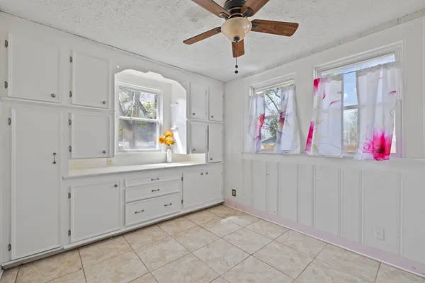 a living room with furniture and a ceiling fan