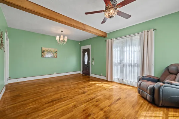 a view of a dining room with furniture and chandelier