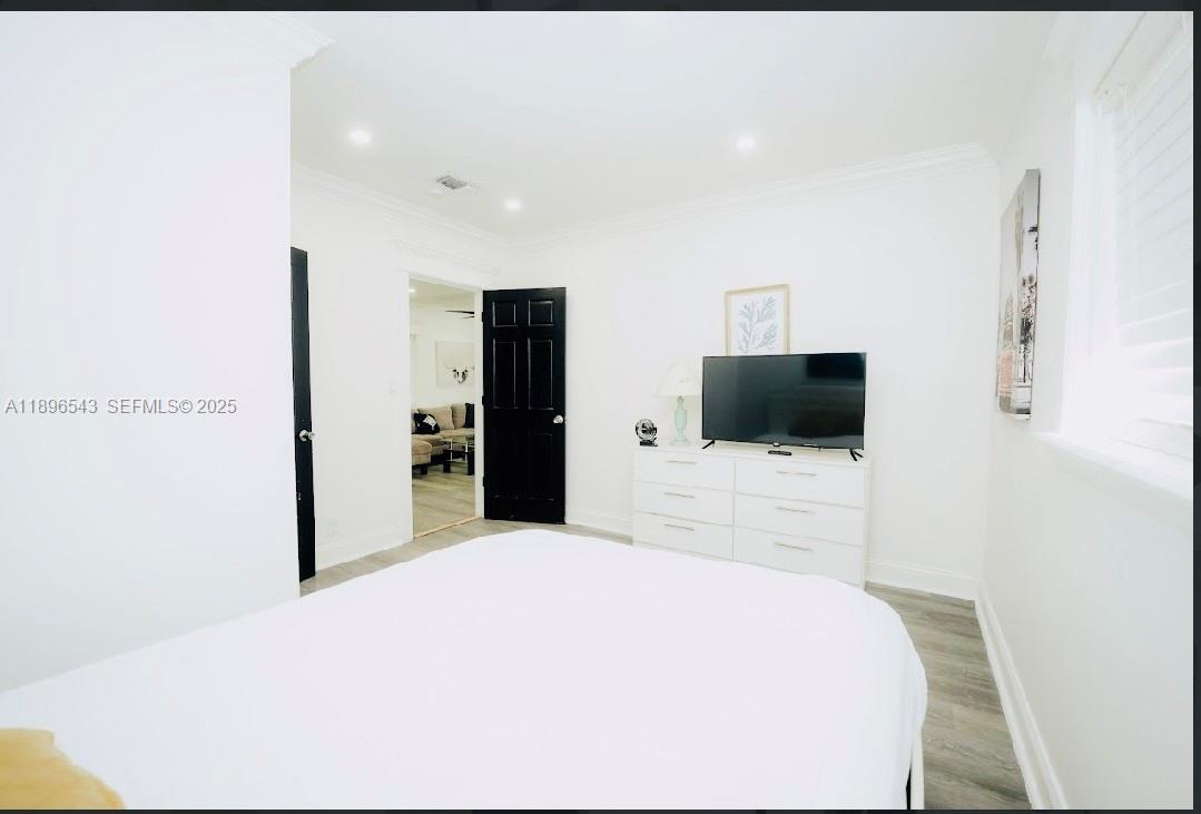 867 Northwest 4th Avenue Homestead, FL 33030 - Photo 11 of 17 a bedroom with a bed and a television