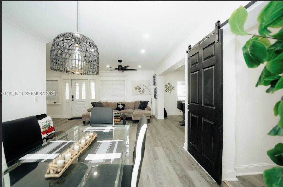 867 Northwest 4th Avenue Homestead, FL 33030 - Photo 12 of 17 a living room with furniture a chandelier and a dining table