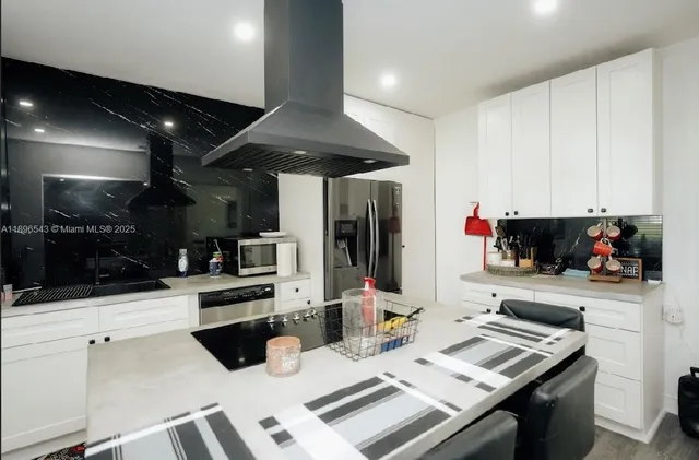 a kitchen with a sink and white cabinets