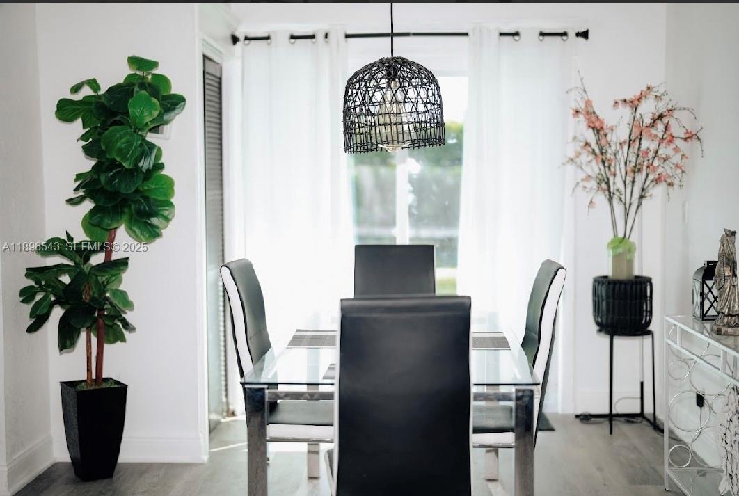 867 Northwest 4th Avenue Homestead, FL 33030 - Photo 14 of 17 a vase of flowers sitting on a table with a potted plant