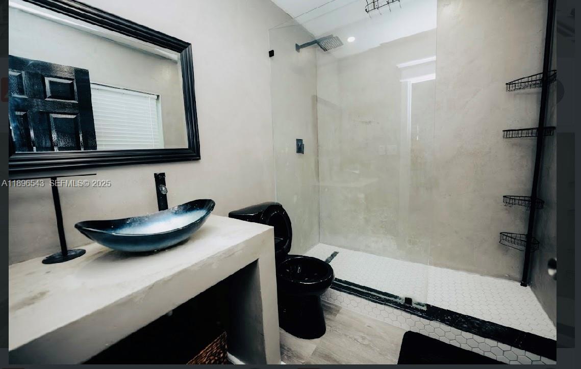 867 Northwest 4th Avenue Homestead, FL 33030 - Photo 5 of 17 a bathroom with a sink a toilet and a mirror
