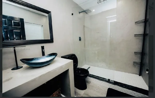 a bathroom with a sink a toilet and a mirror