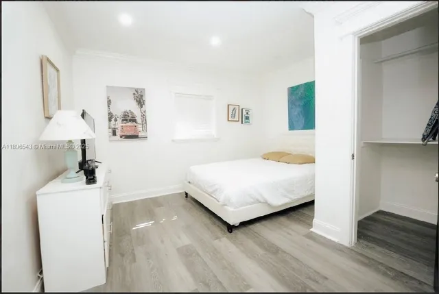 a bedroom with a bed and a lamp on table