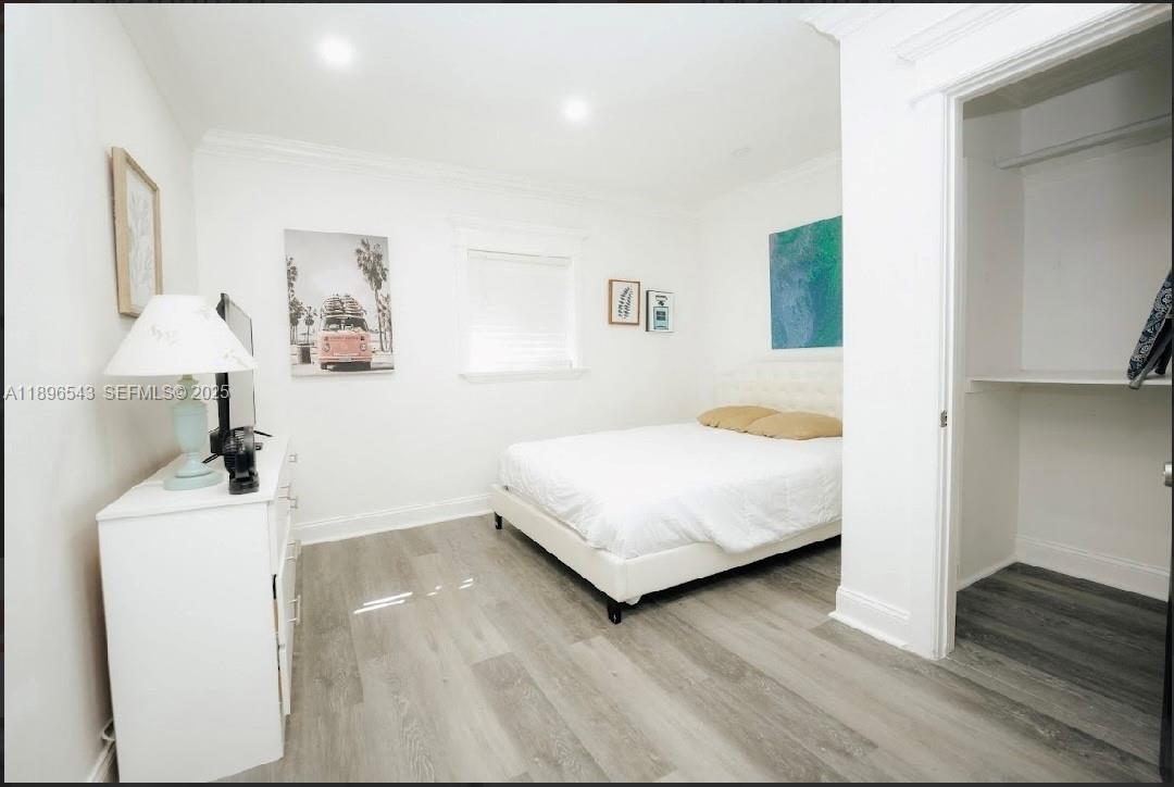 867 Northwest 4th Avenue Homestead, FL 33030 - Photo 9 of 17 a bedroom with a bed and a lamp on table