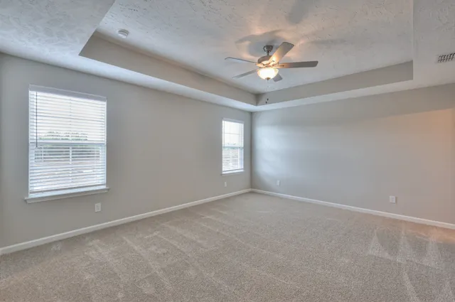 an empty room with closet and fan