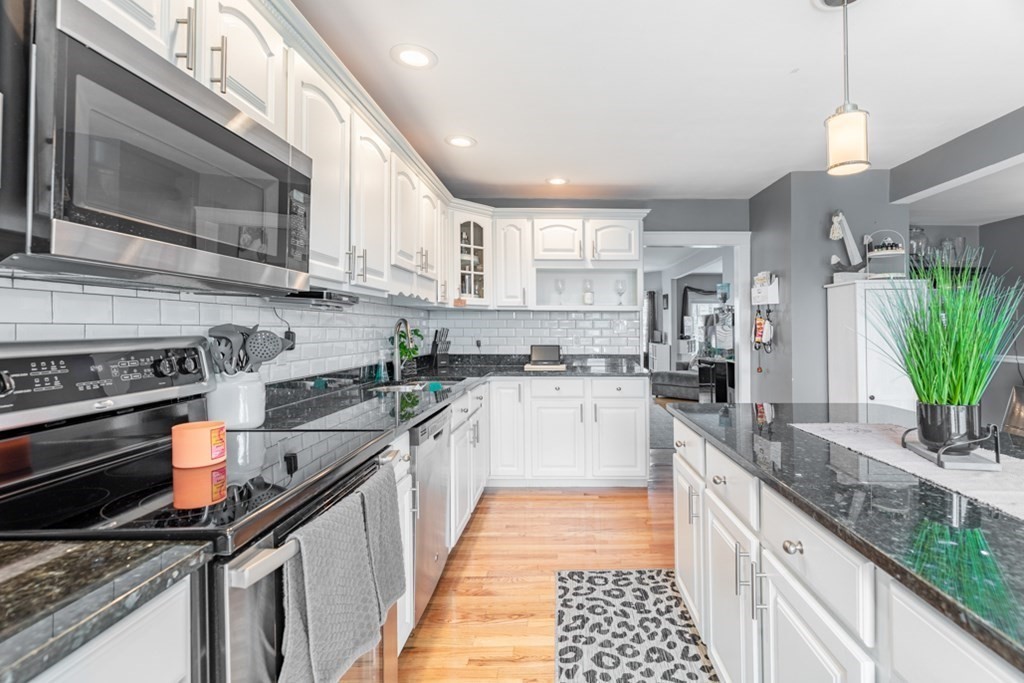 272 River Road Winthrop, MA 02152 - Photo 11 of 42 a kitchen with stainless steel appliances granite countertop a sink a stove and a wooden cabinets