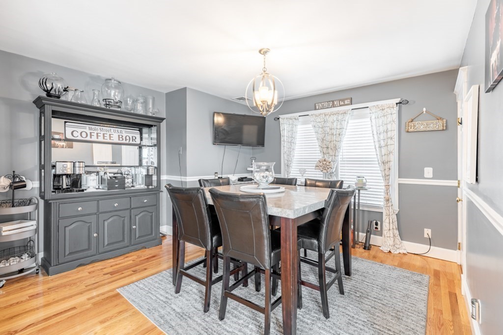 272 River Road Winthrop, MA 02152 - Photo 14 of 42 a dining area with a table chairs and a kitchen view