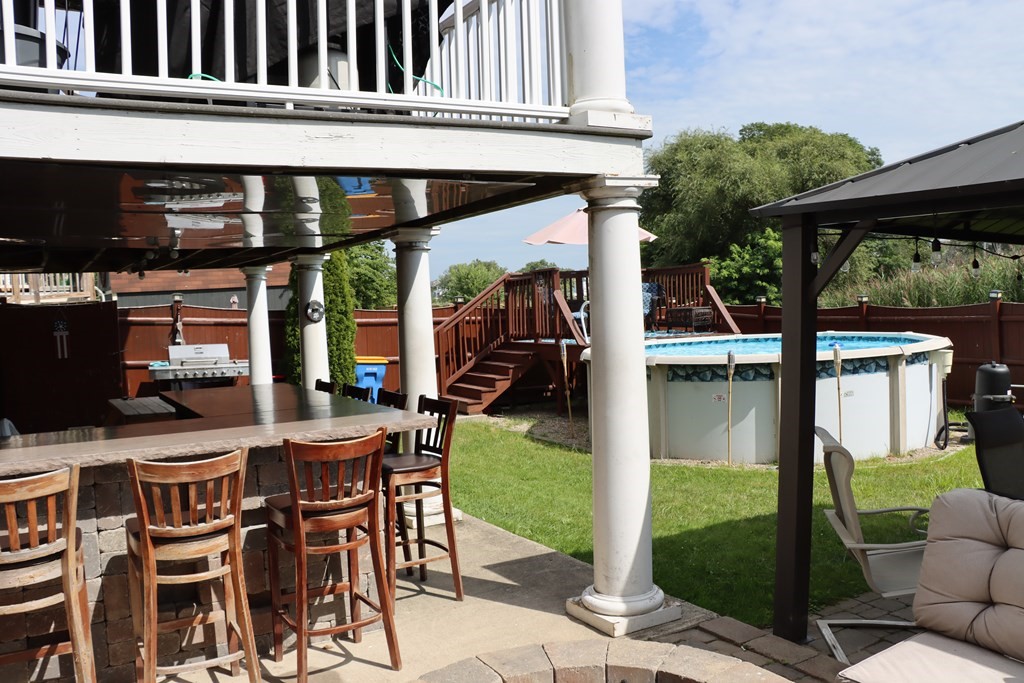 272 River Road Winthrop, MA 02152 - Photo 36 of 42 a view of a patio with table and chairs potted plants and floor to ceiling window
