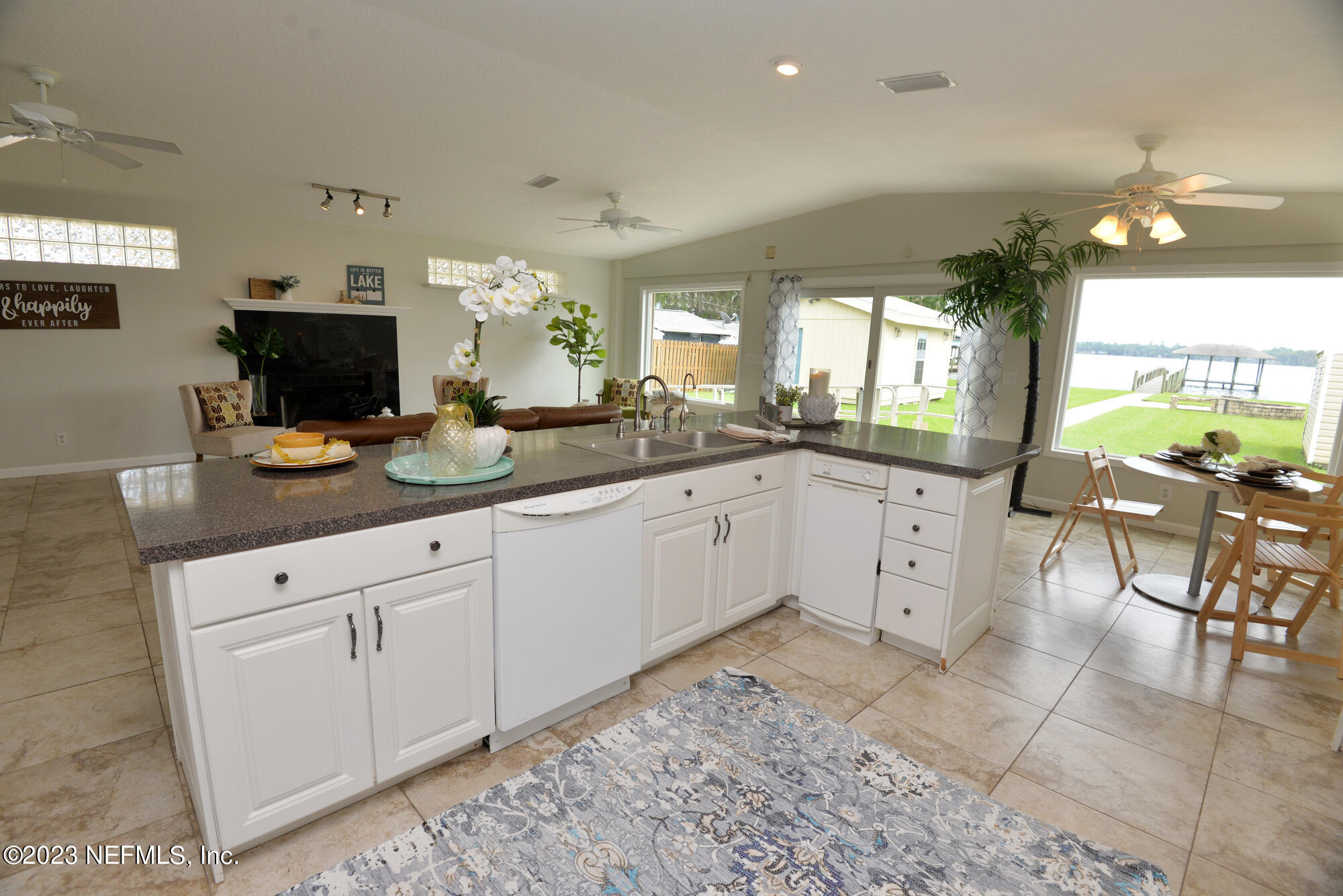 2976 Magnolia Road Orange Park, FL 32065 - Photo 16 of 44 a large white kitchen with a lot of counter space and a wooden floor