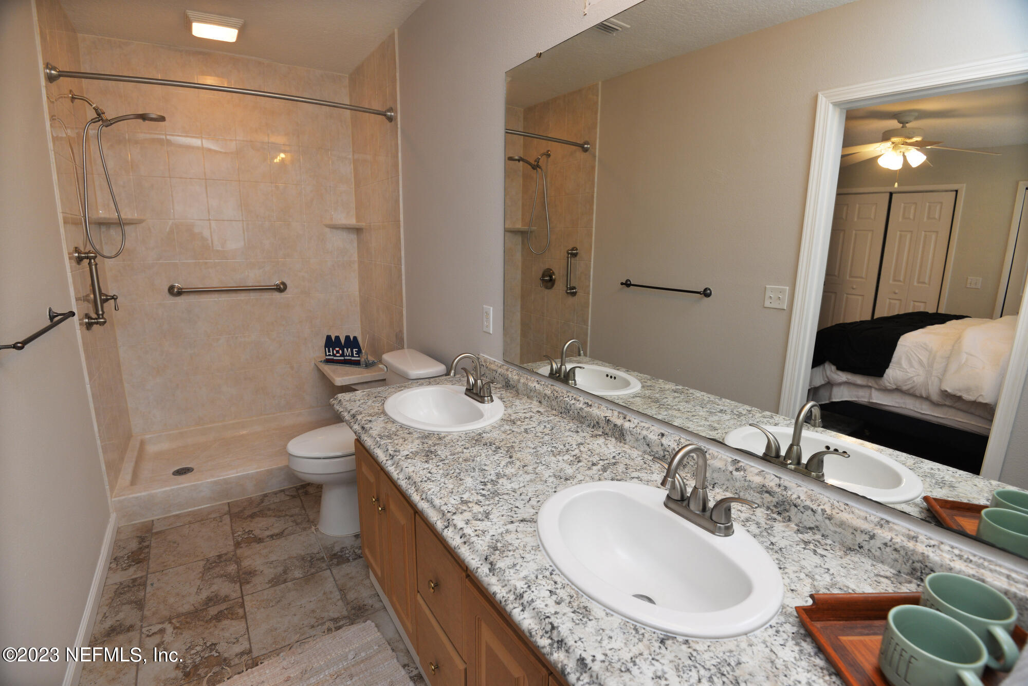 2976 Magnolia Road Orange Park, FL 32065 - Photo 22 of 44 a bathroom with a granite countertop sink a mirror and a toilet