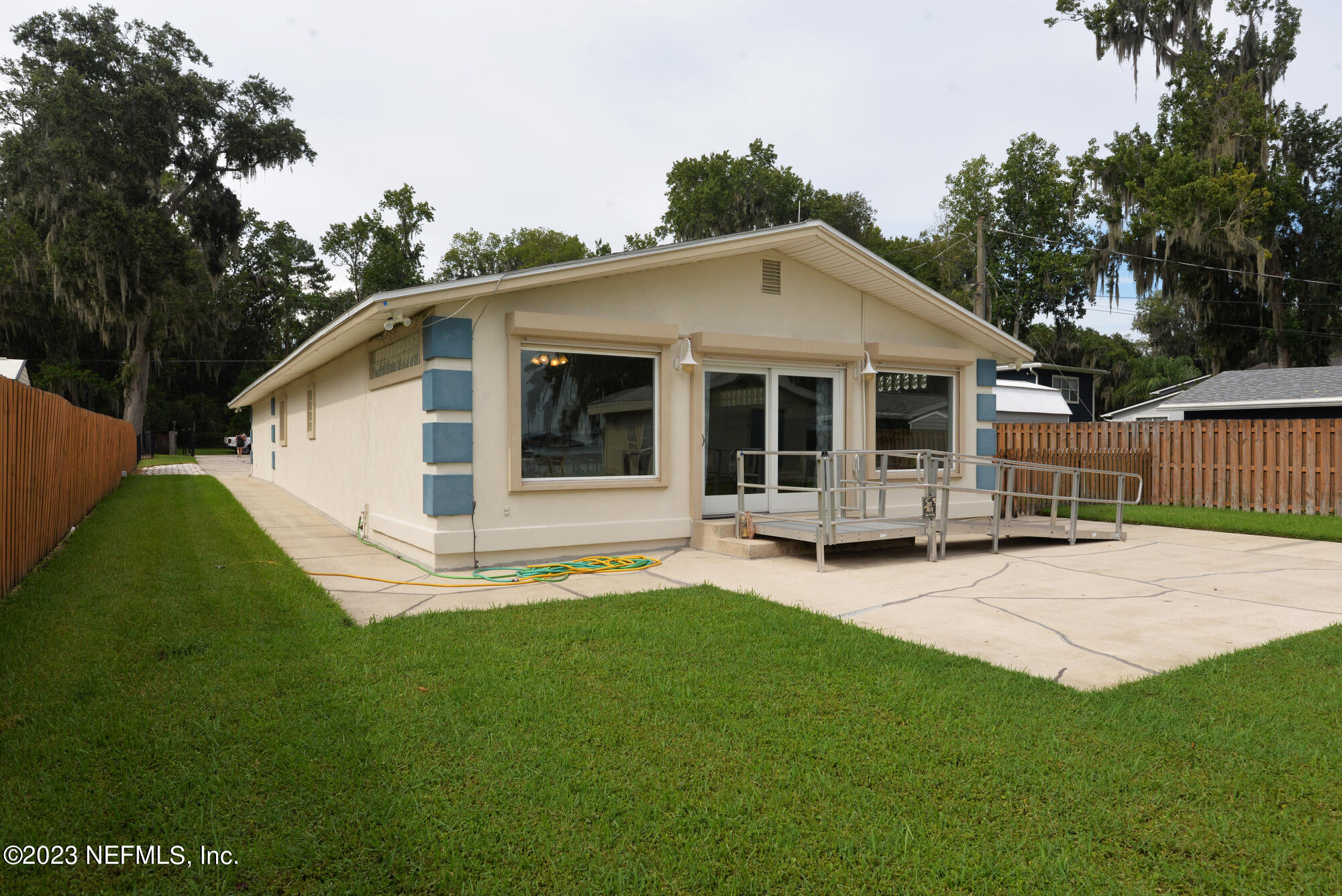2976 Magnolia Road Orange Park, FL 32065 - Photo 41 of 44 a view of a house with a yard and sitting area