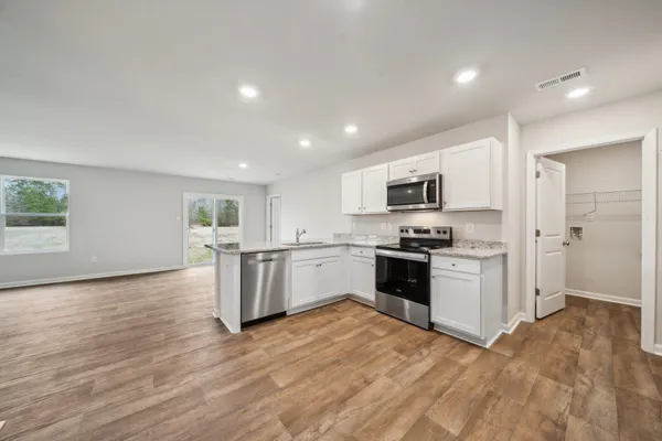 a kitchen with stainless steel appliances granite countertop a stove and a sink