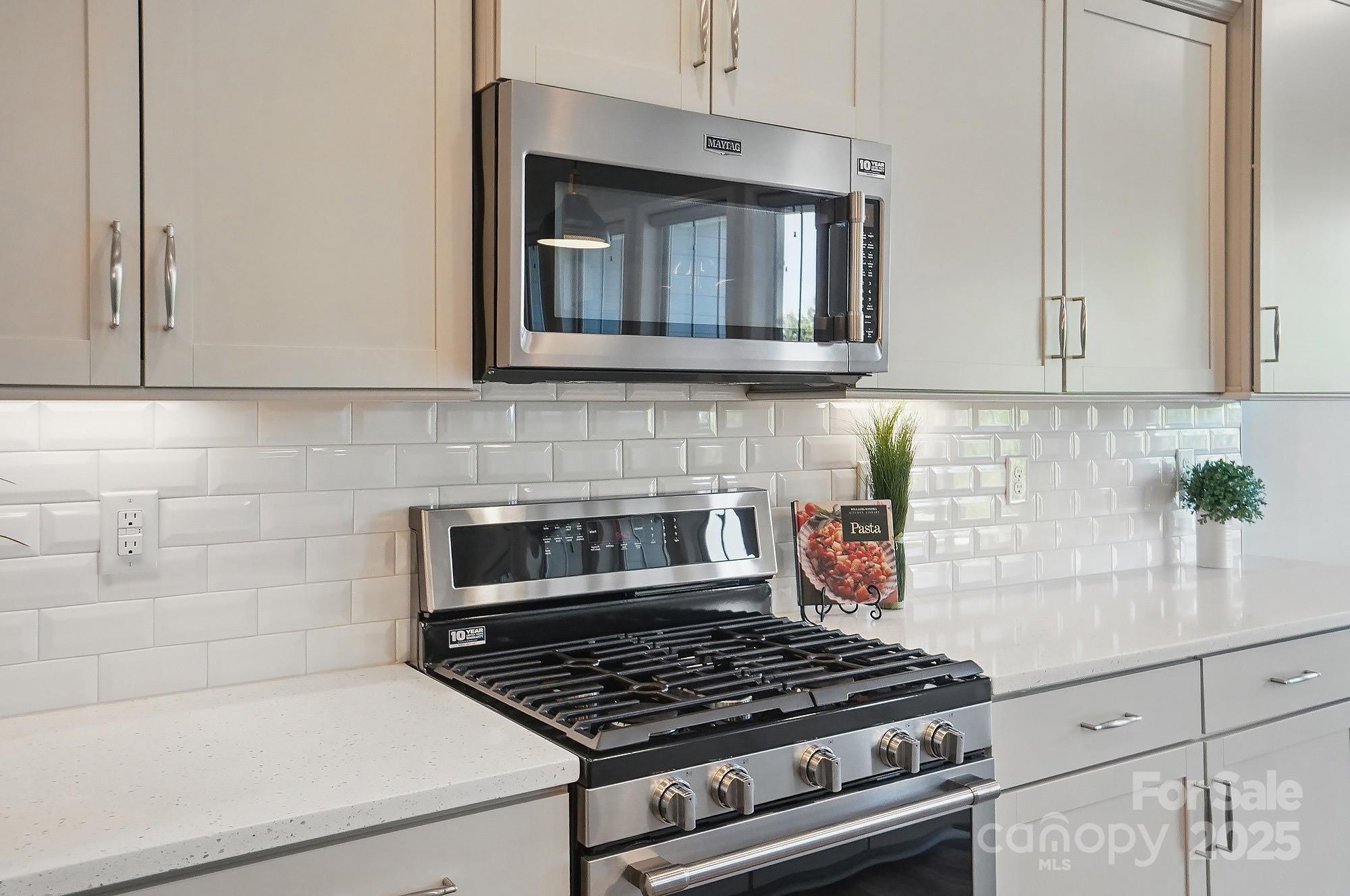 5004 Oakmere Road Waxhaw, NC 28173 - Photo 11 of 48 a kitchen with white cabinets and stove top oven