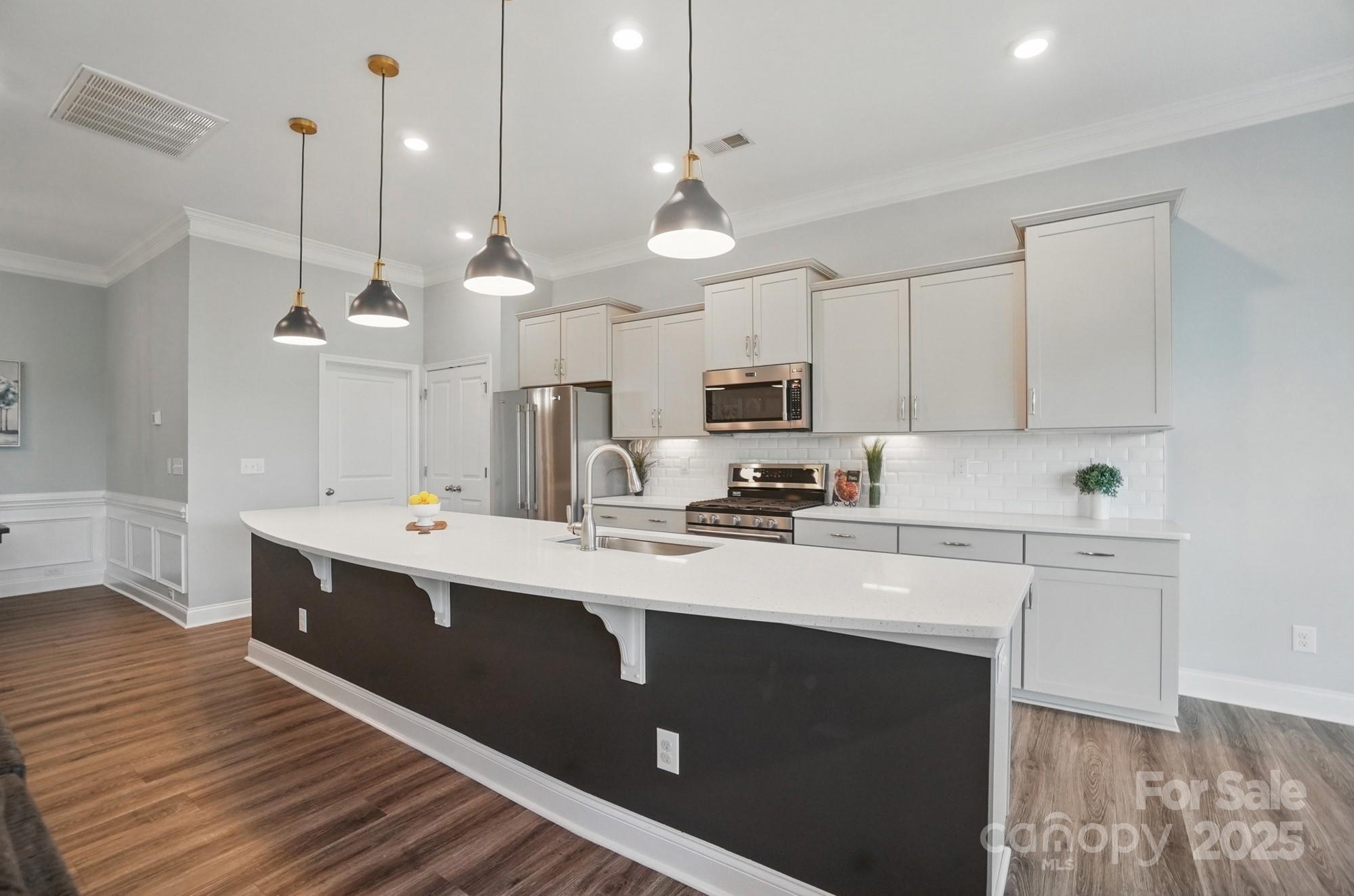 5004 Oakmere Road Waxhaw, NC 28173 - Photo 15 of 48 a kitchen with stainless steel appliances a stove a sink and white cabinets