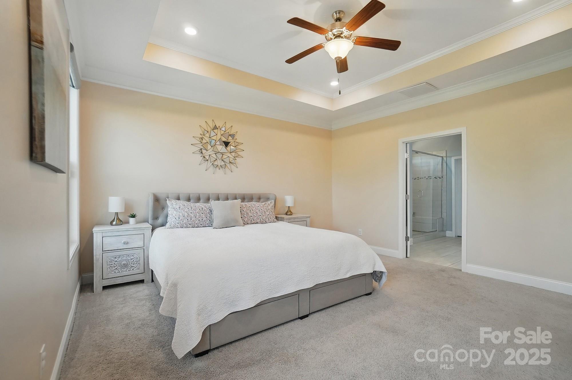 5004 Oakmere Road Waxhaw, NC 28173 - Photo 21 of 48 a bedroom with a bed and a ceiling fan