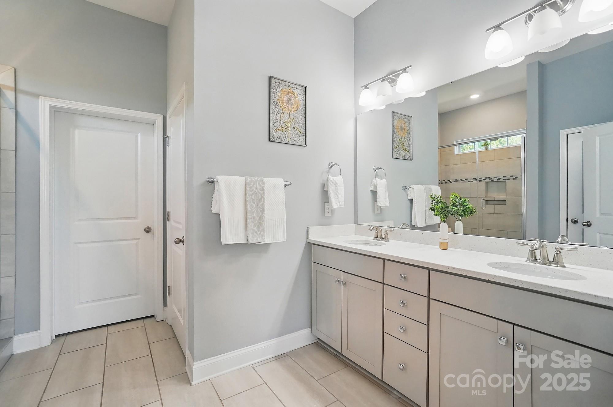 5004 Oakmere Road Waxhaw, NC 28173 - Photo 23 of 48 a bathroom with a double vanity sink and mirror