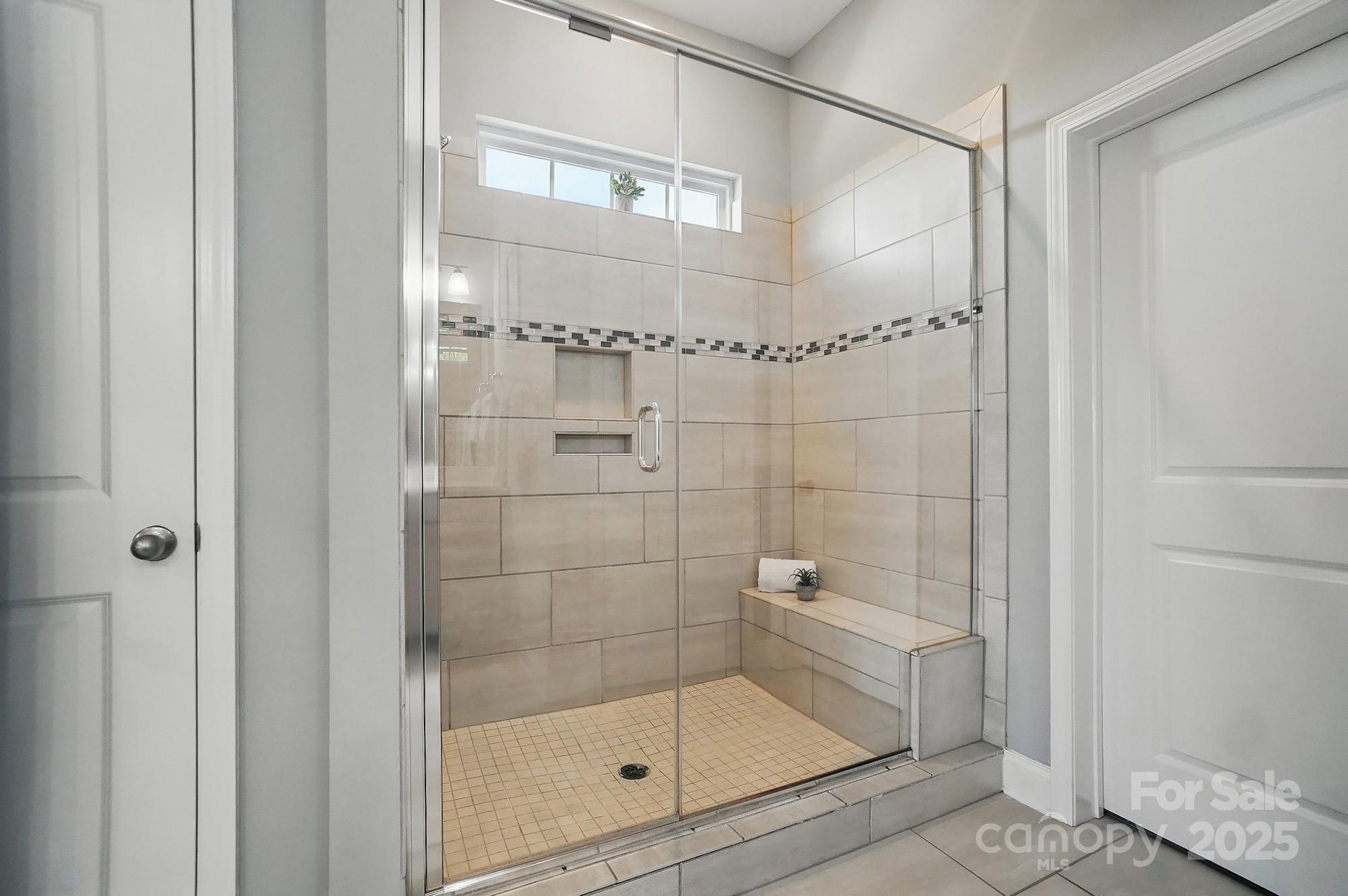 5004 Oakmere Road Waxhaw, NC 28173 - Photo 24 of 48 a bathroom with a glass shower door