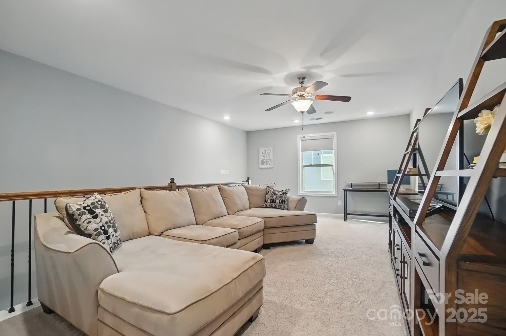 5004 Oakmere Road Waxhaw, NC 28173 - Photo 36 of 48 a living room with furniture and a chandelier