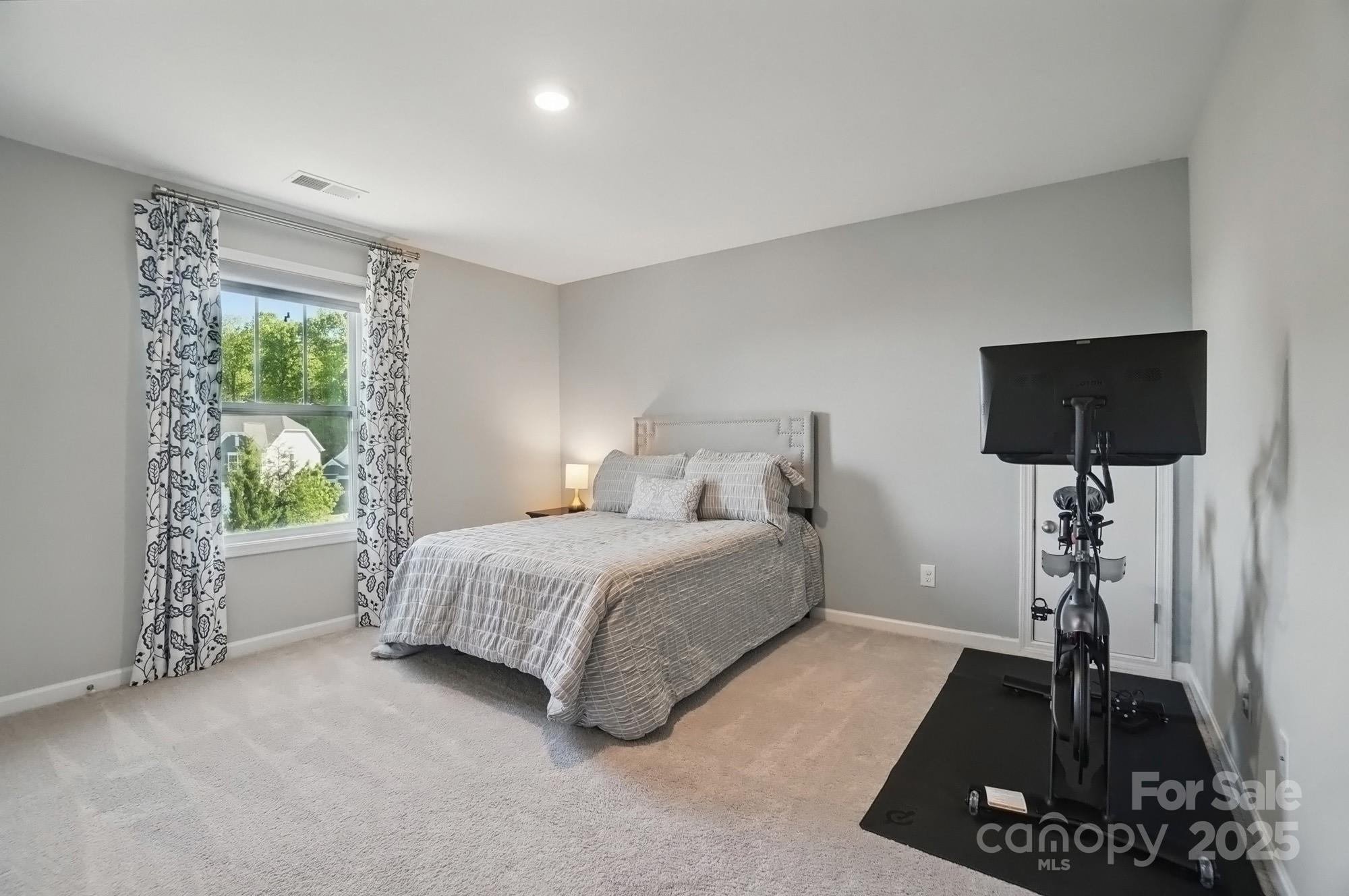 5004 Oakmere Road Waxhaw, NC 28173 - Photo 38 of 48 a bed room with a bed and a night stand